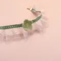 Close-up detail of the cute pet lace choker with a handmade crochet green flower and ribbon. - Verdant