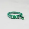Detailed close-up view of the green plaid pet collar showing its secure plastic buckle and ringing bell. - Dark Green