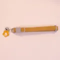 Detailed view of yellow corduroy pet collar featuring cute flower pendant and bell decoration. - Orange
