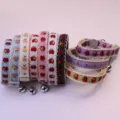 Close-up detail of cute apple print pet collars with delicate lace trim and sweet hanging bells. - 10 Pieces Per Bag