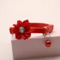 Close-up of red pet collar with fabric flower rhinestone and bell detail for cute cats and dogs. - 1.0cm / Red