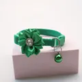 Detail shot of a green pet collar featuring a fabric flower, rhinestone, and bell. - 1.0cm / Green