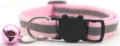 Pet reflective collar detail shot featuring pink nylon strap, safety buckle, and cute bell. - Pink