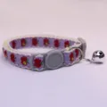Close-up detail of cute purple pet collar with apple pattern, white lace and ringing bell. - Purple Base Red Apple