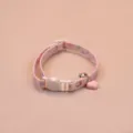 Close-up view of the cute pink cat collar featuring a heart pendant and bell detail. - Pink With Bell
