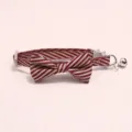 Detailed view of striped pet collar with bow tie and bell for cats and dogs, beautiful. - Burgundy