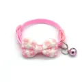 Detailed view of cute pink plaid pet collar with bowknot and bell for cats and dogs. - Pink