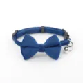 Close-up of blue velvet pet collar with bow and bell, soft texture and secure buckle detail. - Sapphire Blue