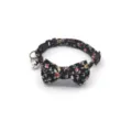 Floral cat collar featuring a cute bow and bell, soft fabric pet accessory close-up view. - Black Buckle Black Floral