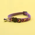 Purple cat collar detail showing metallic gold moon and star print with cute cat buckle. - Purple