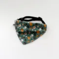 Close-up detail view of the Halloween pet bandana featuring spooky pumpkin and ghost prints with a bell. - 19-31cm / Green