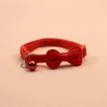 Red pet collar detail view featuring a cute bow and metallic bell for small cats and dogs. - Red