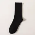 Black ribbed mid-tube sock detail view showing close-up fabric texture and classic design. - Knee-High Socks / 21cm / Black