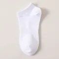 Detailed shot of a clean white low cut ankle sock featuring breathable ribbed cuffs. - No-Show Socks / 5cm / White