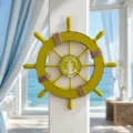 Close-up detail of wooden ship wheel wall hanging, Mediterranean marine style decoration. - 28cm / Yellow