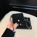 Black suede mini crossbody bag detail, chic women lipgloss pouch with beads and patterned strap. - Black