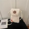 Detailed view of white plush mini crossbody phone bag featuring a cute brown flower decoration. - Off White