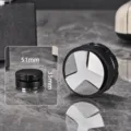 Close up detail view of 51mm black ABS three blade coffee distributor and tamper tool. - ABS + Aluminum Base 51mm