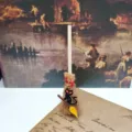 Mini witch broom detail view, featuring a cute black cat charm, perfect for holiday decoration. - 10cm / Black Cat