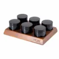 Set of 6 amber cosmetic jars with black lids displayed on a wooden stand for storage. - Walnut Wood 6-Grid