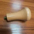 Solid wood coffee tamper handle detail showing smooth texture and threaded screw interface. - Light Wood
