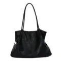 Detail view of the soft black leather tote bag with slim double shoulder straps and slouchy design. - No Pendant / Black