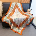 Detail view of 130cm silk square scarf with rabbit and floral print, orange border. - 130x130cm / Orange