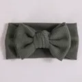 Bandeau nœud tricot gaufré bébé, accessoire cheveux nœud surdimensionné vert foncé nourrisson. - Vert foncé