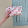 Close-up detail of the pink strawberry print cosmetic bag with convenient zipper closure. - M / Berry Pattern