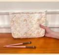 Cute cartoon quilted cosmetic bag detail view, portable large capacity storage pouch for travel. - Quilted Spring Puppy / L