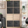 Foldable black fabric storage boxes displayed in a modern wooden cubby shelf for home organization. - 30x30x15cm / Black