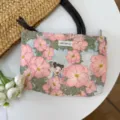 Floral canvas makeup bag with cartoon girl print and convenient handles for daily use. - Little Lady Among Flowers