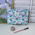 Floral print cotton cosmetic bag detailed view, elegant purple rose pattern with zipper closure. - Purple Mist Rose