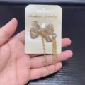 Gold-tone rhinestone bow brooch with hanging tassel chains, elegant suit lapel pin accessory. - Bowknot Style (14)