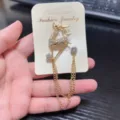 Close-up detail of rhinestone deer brooch with hanging chains sparkling crystals and metal alloy. - Deer Style (1)