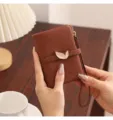 Brown leather short wallet detail view, featuring elegant leaf metal buckle and strap. - Dark Brown