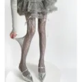 Close-up detail of gray lace fishnet pantyhose with elegant ribbon bow for women fashion. - Gray