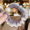Elegant pearl hair scrunchie with lace ruffle design, stylish hair accessory for women. - Purple