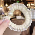 Elegant white pearl ruffled hair scrunchie for women, cute daily hair tie detail shot. - Beige