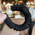 Black ruffled hair scrunchie with elegant pearl charm, perfect fashion accessory for women daily styling. - Black