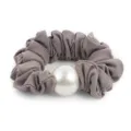 Detailed closeup of grey fabric hair scrunchie featuring a large elegant pearl decoration. - Gray
