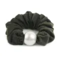 Dark green wool scrunchie detail view with a large white pearl for elegant hairstyles. - Dark Green