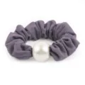 Close-up detail of the purple honeycomb fabric hair scrunchie featuring a large elegant white pearl. - Grey Purple