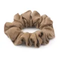 Detailed view of brown wool scrunchie, elegant hair accessory for autumn and winter styling. - Caramel color