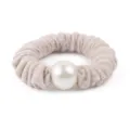 Detailed view of a chic wool textured hair scrunchie featuring a large pearl ornament. - Oatmeal