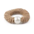 Close-up detail of the brown wool scrunchie featuring a large white pearl decoration. - Caramel color