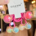 Close-up of colorful disco hair tie featuring iridescent faceted beads and pink elastic bands. - Rose Red