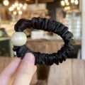 Black satin hair scrunchie with a large white pearl detail for chic elegant buns. - M / Black