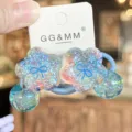 Detailed view of blue glitter flower hair tie with clear hanging balls, sweet kids accessory. - Blue
