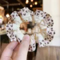 Close-up of heart print hair scrunchie with ruffled edge, soft fabric daily hair accessory. - S / Beige